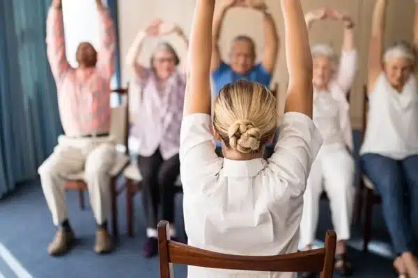 Busy American adult doing quick desk yoga stretch at work for stress relief and focus