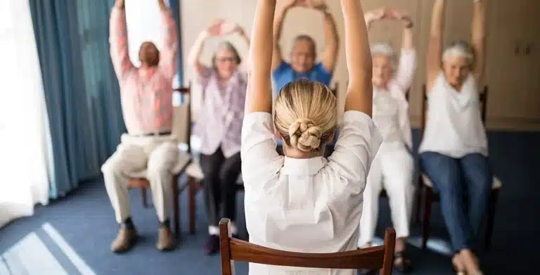 Busy American adult doing quick desk yoga stretch at work for stress relief and focus