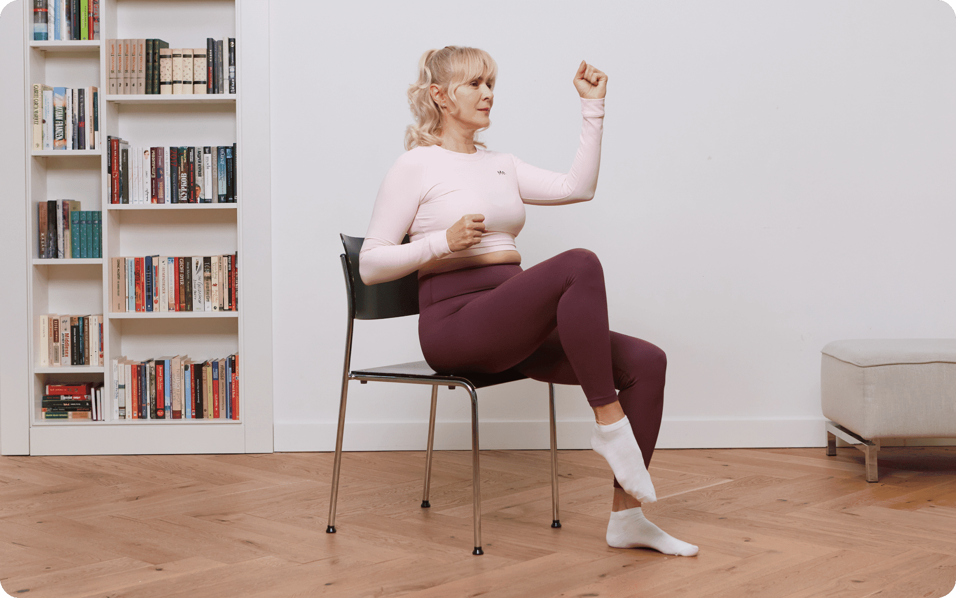 Senior woman practicing gentle chair yoga at home for flexibility and relaxation – safe for over 60