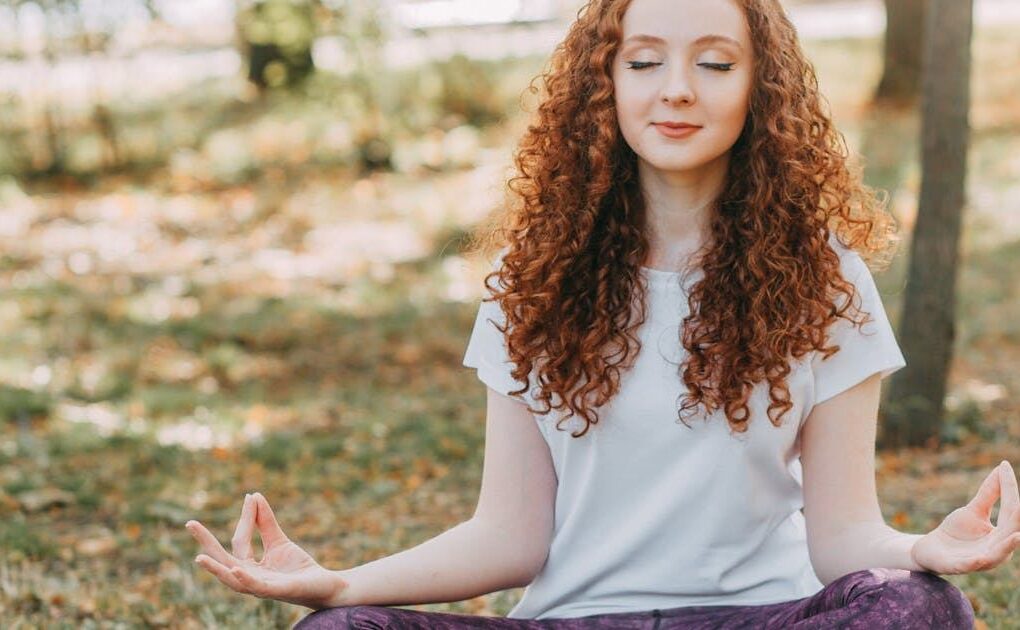Meditating outdoors at sunrise for natural stress relief