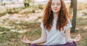 Meditating outdoors at sunrise for natural stress relief