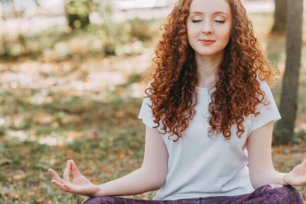 Meditating outdoors at sunrise for natural stress relief